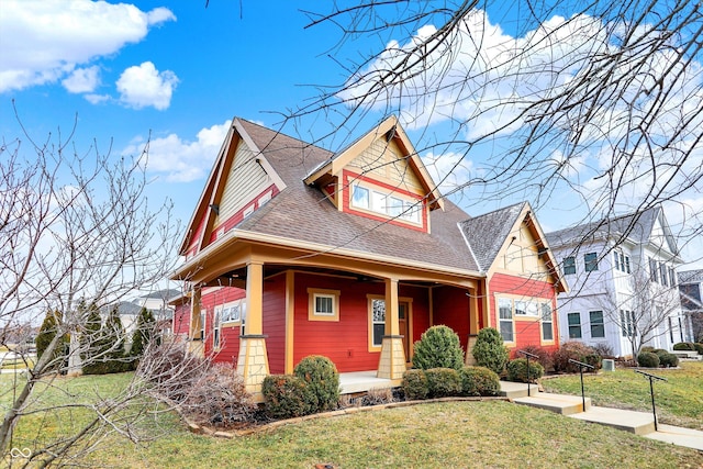 view of front of house featuring a porch, a front yard, and roof with shingles