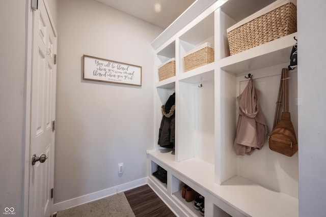 mudroom featuring dark wood-style floors and baseboards