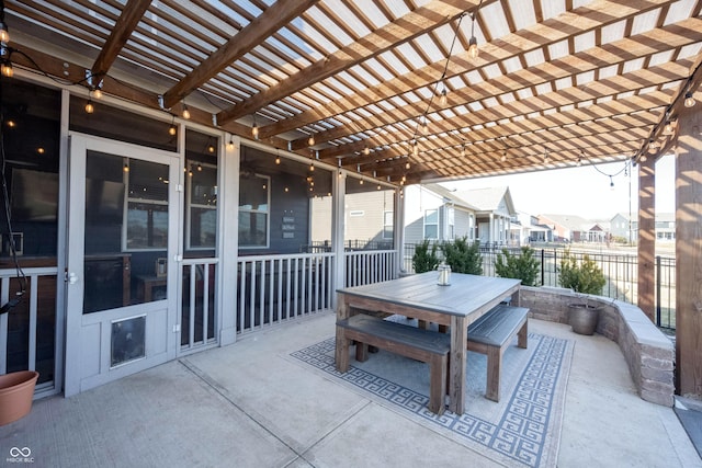 view of patio / terrace featuring outdoor dining area, fence, a pergola, and a residential view