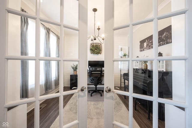 interior space featuring french doors and a notable chandelier