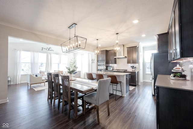 dining space featuring baseboards, an inviting chandelier, dark wood-style floors, and crown molding