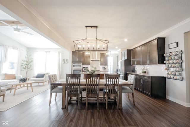 dining space with dark wood-type flooring, crown molding, baseboards, and ceiling fan