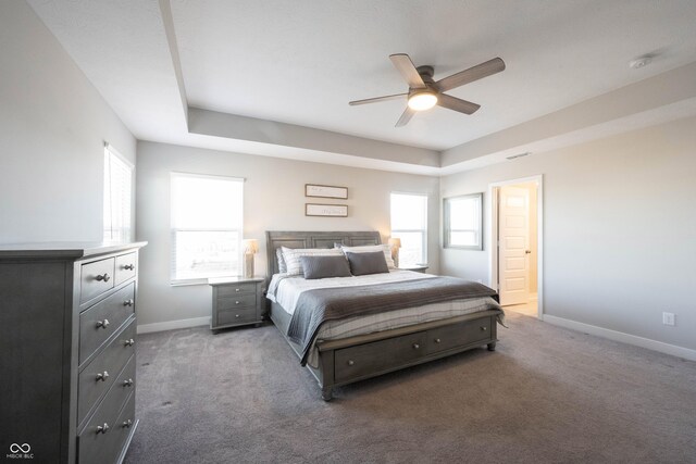 bedroom featuring multiple windows, carpet, and baseboards