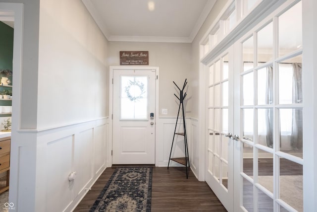 doorway featuring dark wood-style floors, wainscoting, french doors, and crown molding