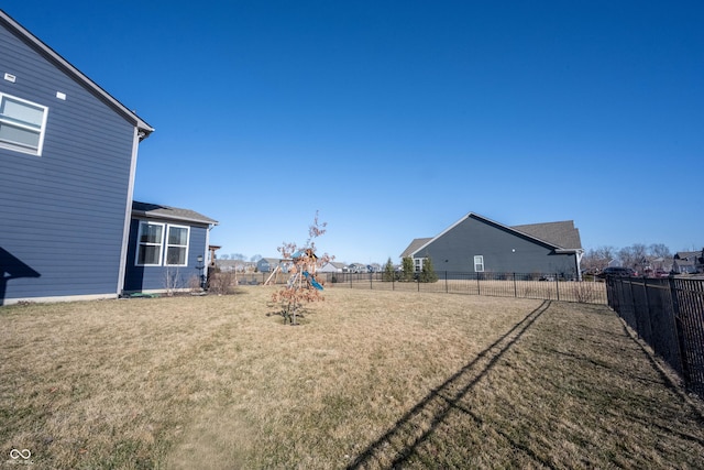 view of yard with a playground and a fenced backyard