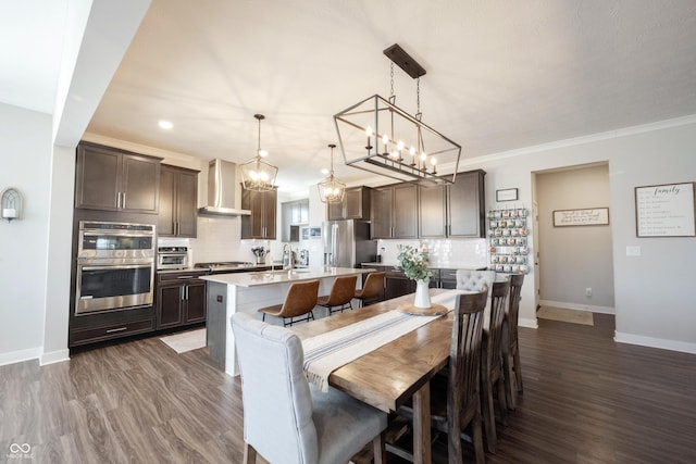 dining space featuring baseboards, dark wood finished floors, and crown molding