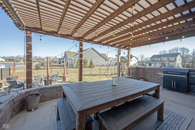 view of patio featuring outdoor dining area, fence, a pergola, and a residential view