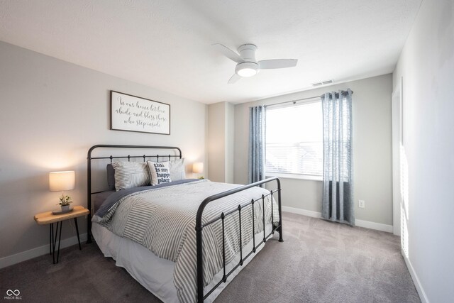 carpeted bedroom with visible vents, baseboards, and ceiling fan