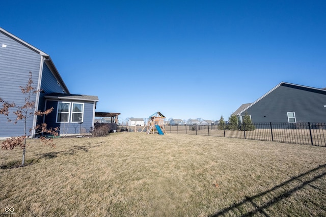 view of yard with a playground and fence