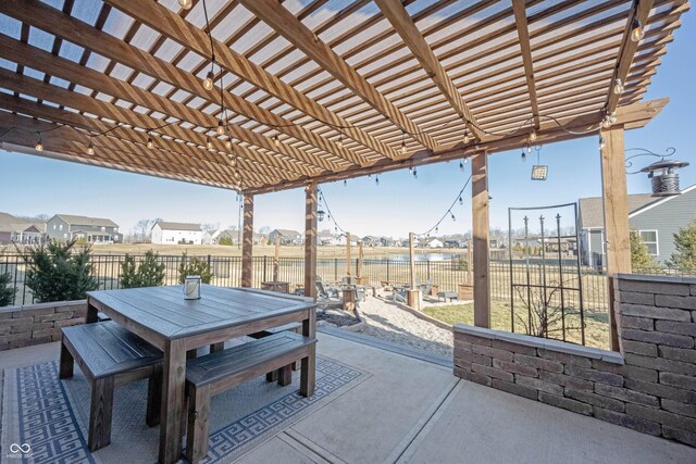 view of patio with outdoor dining area, fence, and a pergola