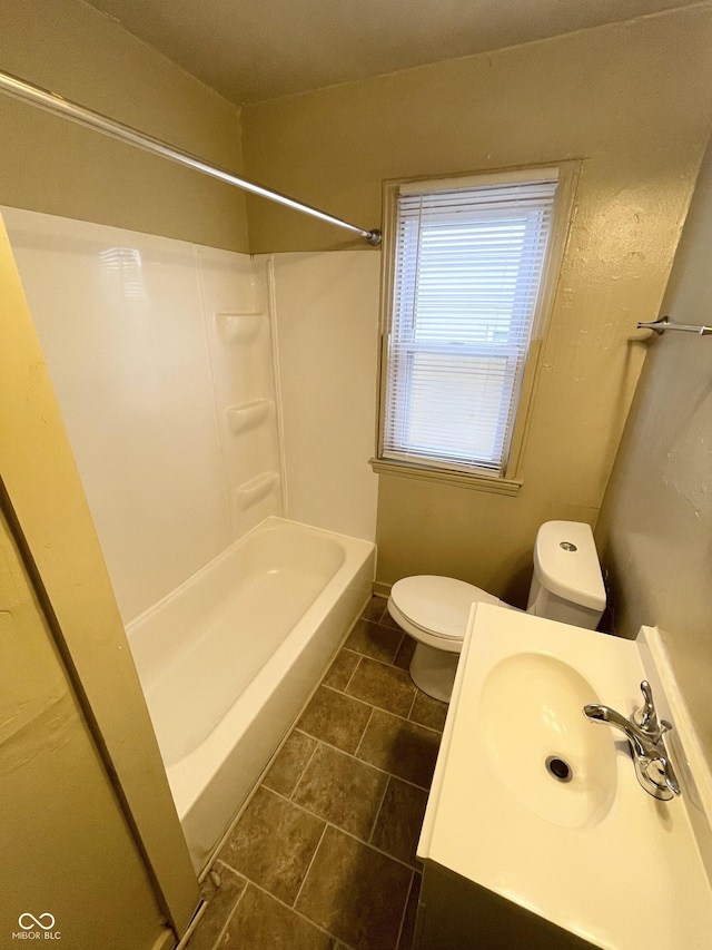 full bath featuring vanity, bathing tub / shower combination, and toilet