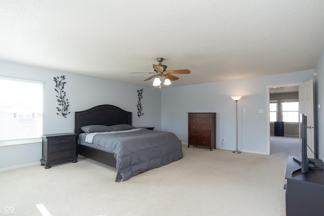 bedroom with carpet, ceiling fan, a textured ceiling, and baseboards