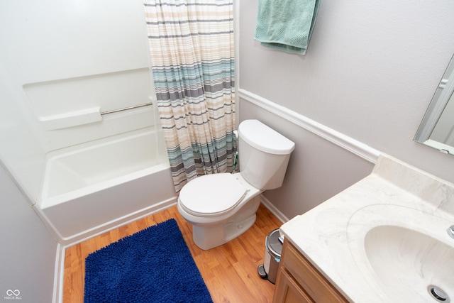 full bath featuring shower / bath combo, vanity, toilet, and wood finished floors