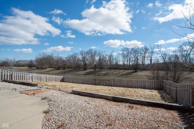 view of yard with a fenced backyard and a rural view