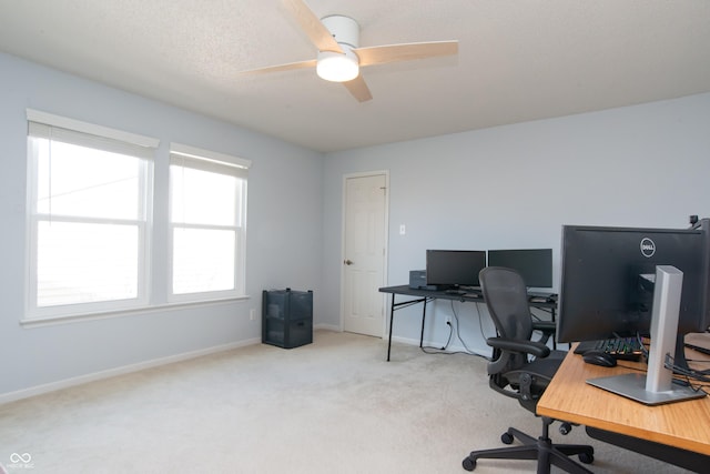 home office featuring carpet, baseboards, and ceiling fan