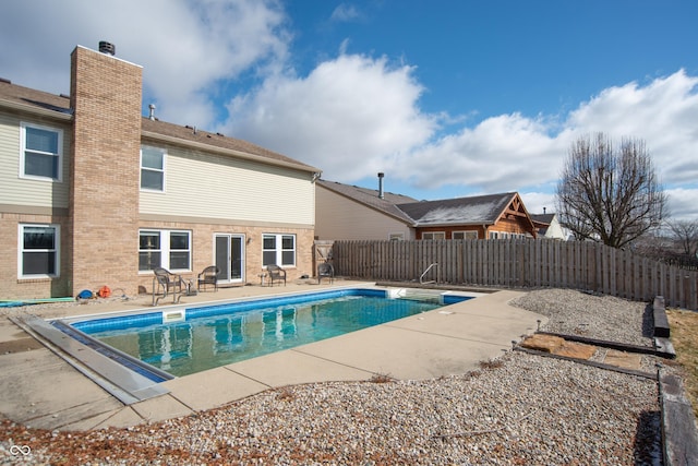 view of pool featuring a patio area, a fenced backyard, and a fenced in pool