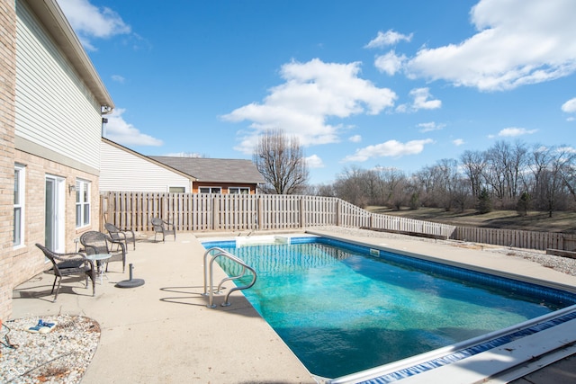 view of swimming pool featuring a fenced backyard, a fenced in pool, and a patio