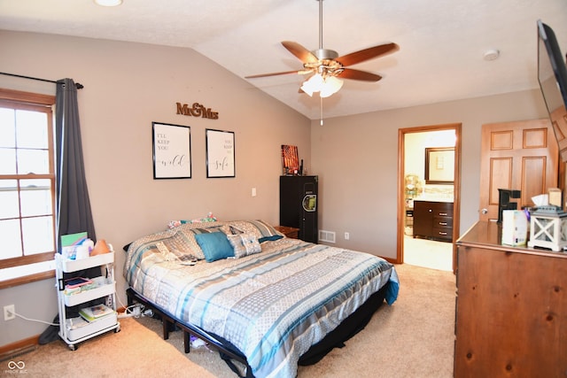 bedroom featuring ceiling fan, light carpet, visible vents, baseboards, and vaulted ceiling