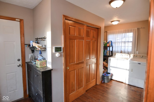 washroom featuring laundry area, dark wood finished floors, a textured ceiling, and washing machine and clothes dryer