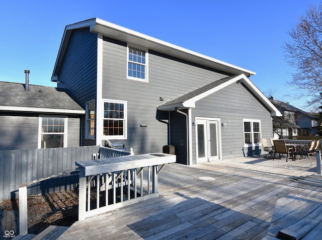 wooden deck with french doors, outdoor dining area, area for grilling, and fence