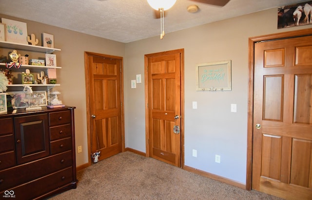 carpeted bedroom featuring baseboards and a textured ceiling