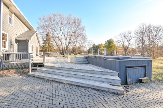 deck with a patio area and a hot tub