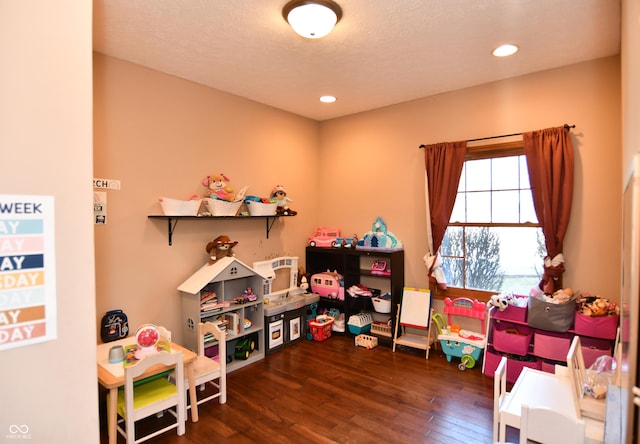 game room featuring a textured ceiling, wood finished floors, and recessed lighting