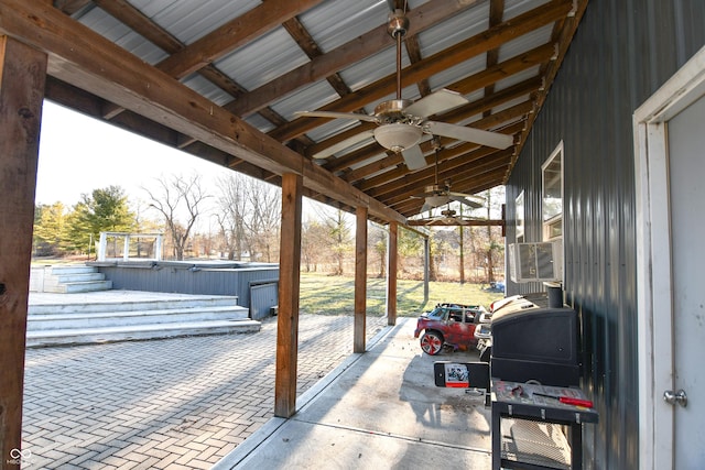 view of patio with a jacuzzi, ceiling fan, and cooling unit