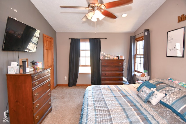 bedroom with lofted ceiling, ceiling fan, light carpet, and baseboards