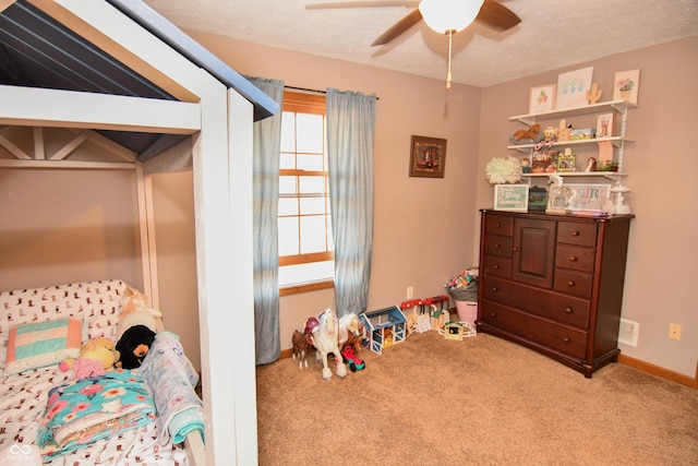 carpeted bedroom featuring a ceiling fan, baseboards, and a textured ceiling