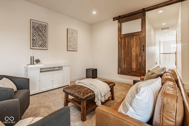 carpeted living area with recessed lighting, a barn door, baseboards, and visible vents