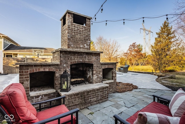 view of patio featuring an outdoor brick fireplace