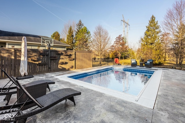 view of pool with a fenced in pool, a patio, and fence