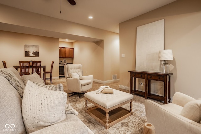 living room featuring recessed lighting, visible vents, baseboards, and light colored carpet