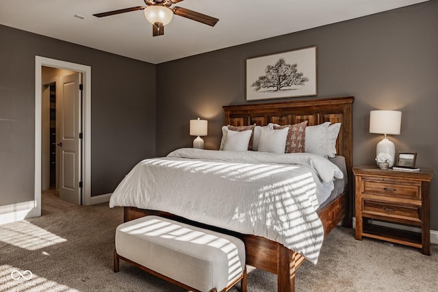 carpeted bedroom with baseboards and a ceiling fan