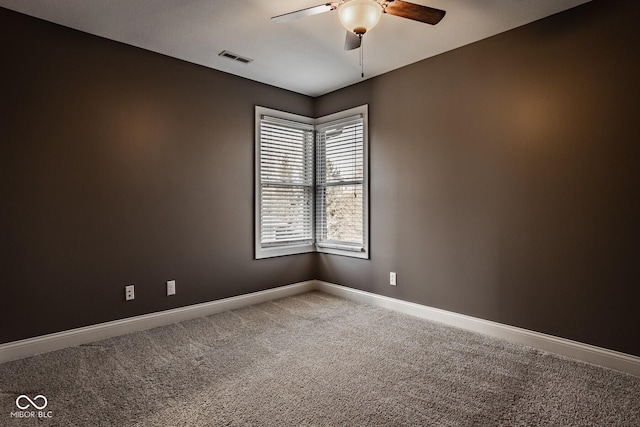 unfurnished room featuring carpet flooring, visible vents, baseboards, and ceiling fan