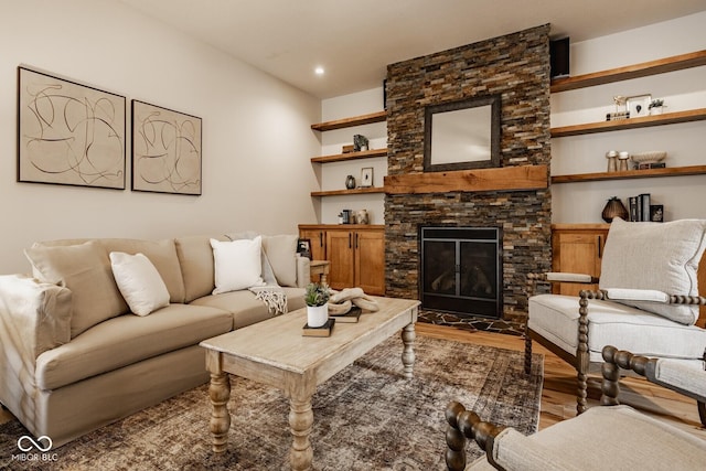 living room with recessed lighting, wood finished floors, and a fireplace