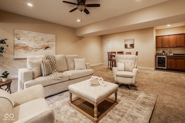 living area with beverage cooler, recessed lighting, light carpet, and baseboards