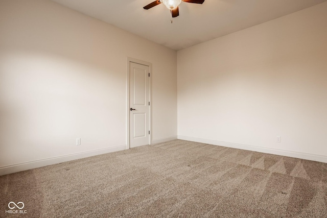 empty room featuring baseboards, carpet floors, and ceiling fan