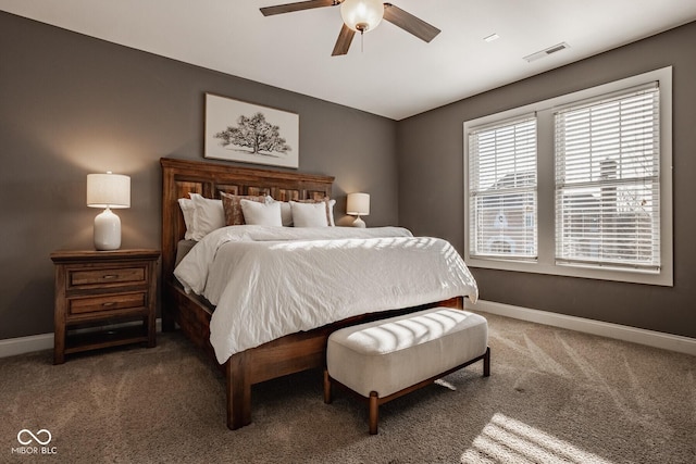 carpeted bedroom featuring baseboards, visible vents, and ceiling fan