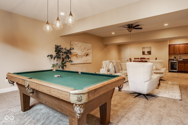 game room featuring baseboards, wine cooler, light colored carpet, and wet bar