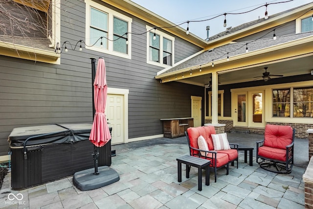 view of patio / terrace with ceiling fan and a hot tub