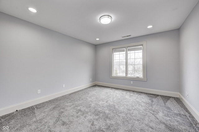 empty room with recessed lighting, carpet flooring, baseboards, and visible vents