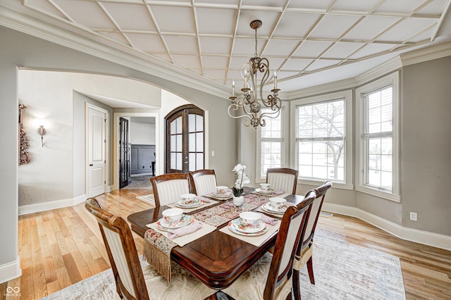 dining room featuring baseboards, an inviting chandelier, arched walkways, light wood-style floors, and french doors