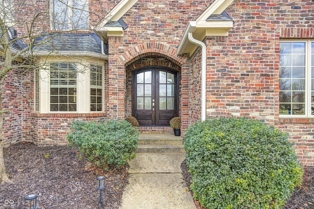 doorway to property with brick siding and french doors