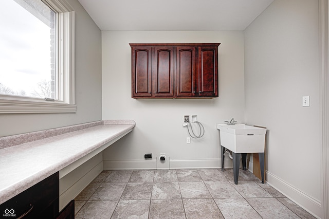 laundry room with baseboards, light tile patterned floors, hookup for a washing machine, cabinet space, and electric dryer hookup