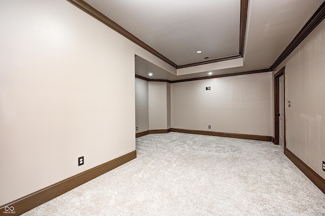 spare room featuring crown molding, baseboards, light carpet, recessed lighting, and a raised ceiling