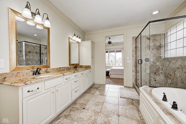 ensuite bathroom featuring double vanity, ornamental molding, a stall shower, and a sink