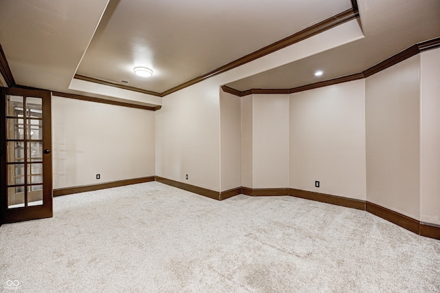 basement featuring ornamental molding, baseboards, and carpet floors