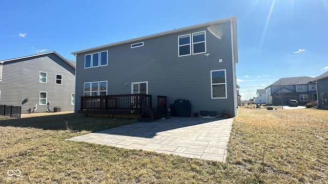 back of house with a deck, a patio, a yard, and cooling unit